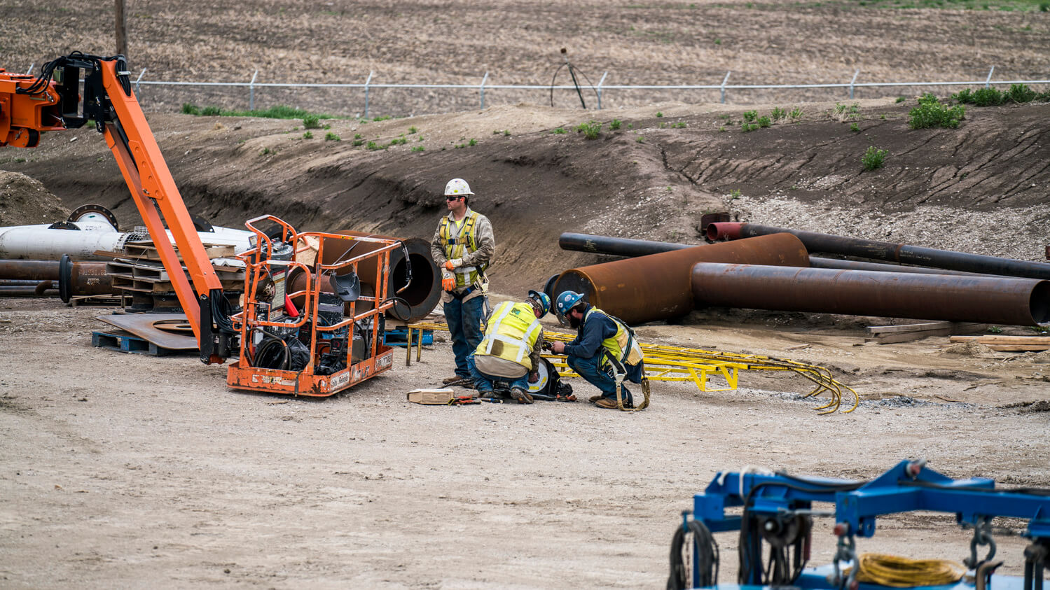 Employees collaborating on work site